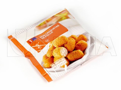 Conditionnement de croquettes de poulet congelées sur une ensacheuse verticale avec film laminé et LDPE.